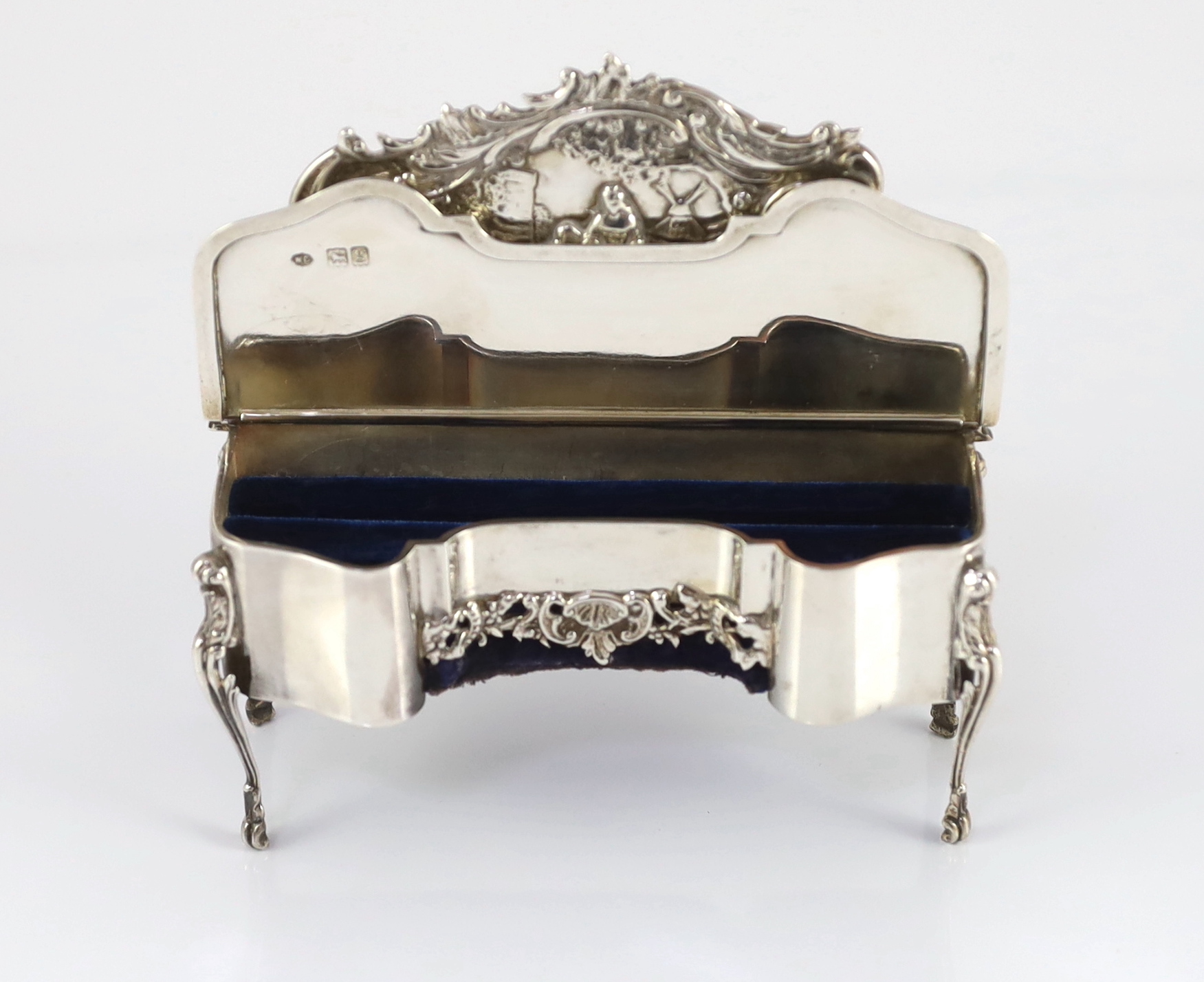 An Edwardian embossed silver novelty trinket box, modelled as a dressing table with raised back, on cabriole legs, by William Comyns